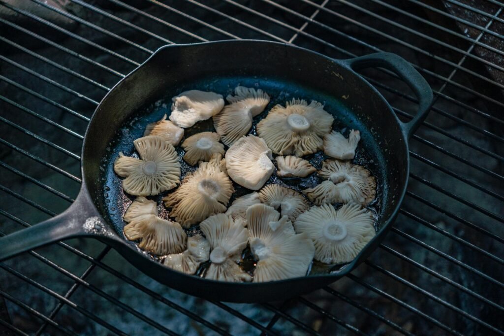 Mushrooms browning deeply in a skillet