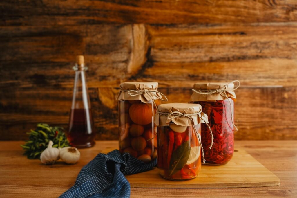 Pantry flavor builders like tomato paste, vinegar, soy sauce, spices, and lemon on a kitchen counter