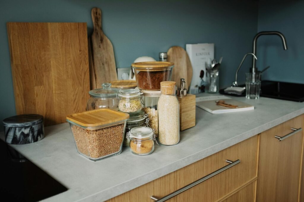 A few small spice jars beside a grocery receipt and a meal-planning notebook