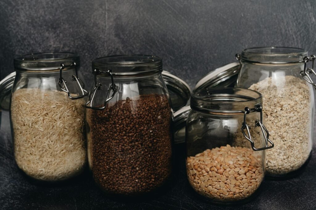 A handwritten meal plan and shopping list next to basic pantry and produce items.