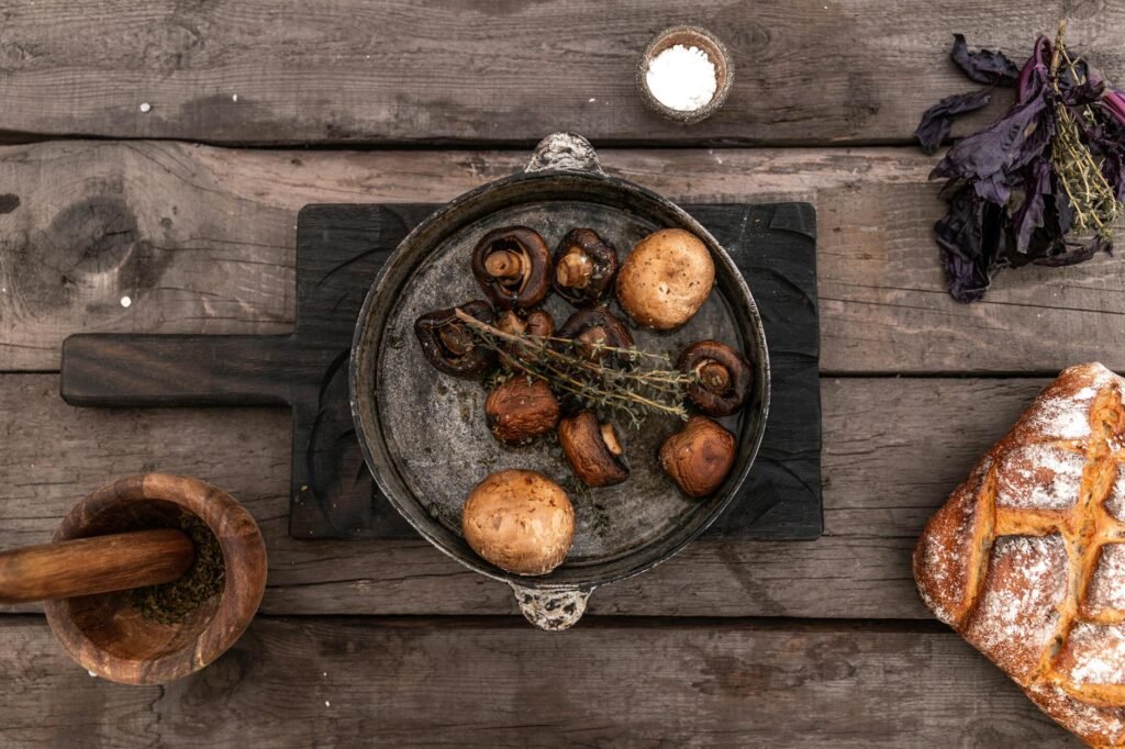 A skillet of browned mushrooms and lentils cooking on the stove