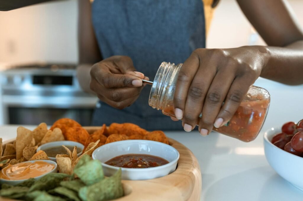 Hands holding two packaged sauces and comparing their nutrition labels.