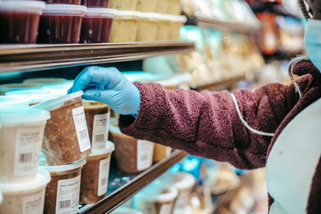 A shopper checking the Nutrition Facts label on a packaged plant-based product