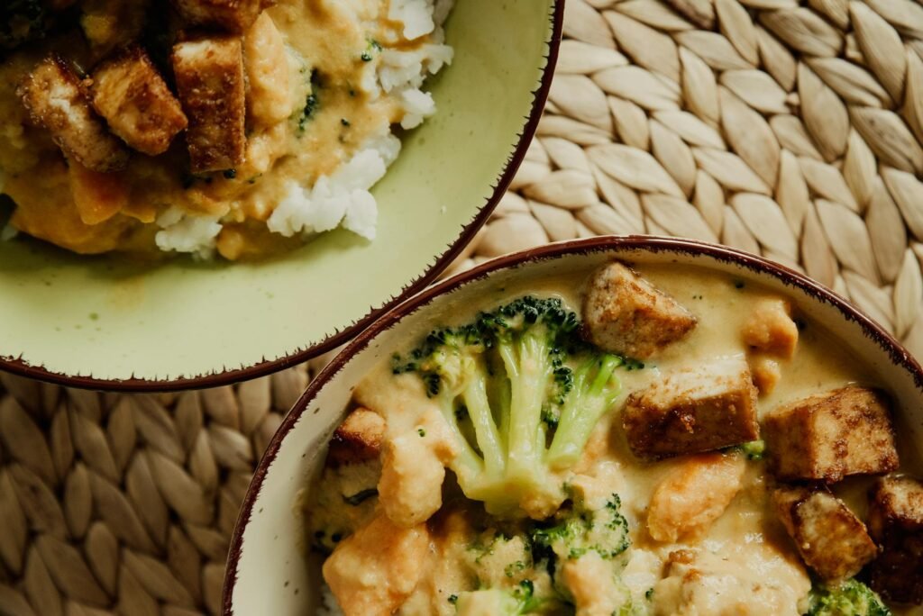 Roasted vegetables and grain bowls served with two creamy vegan sauces