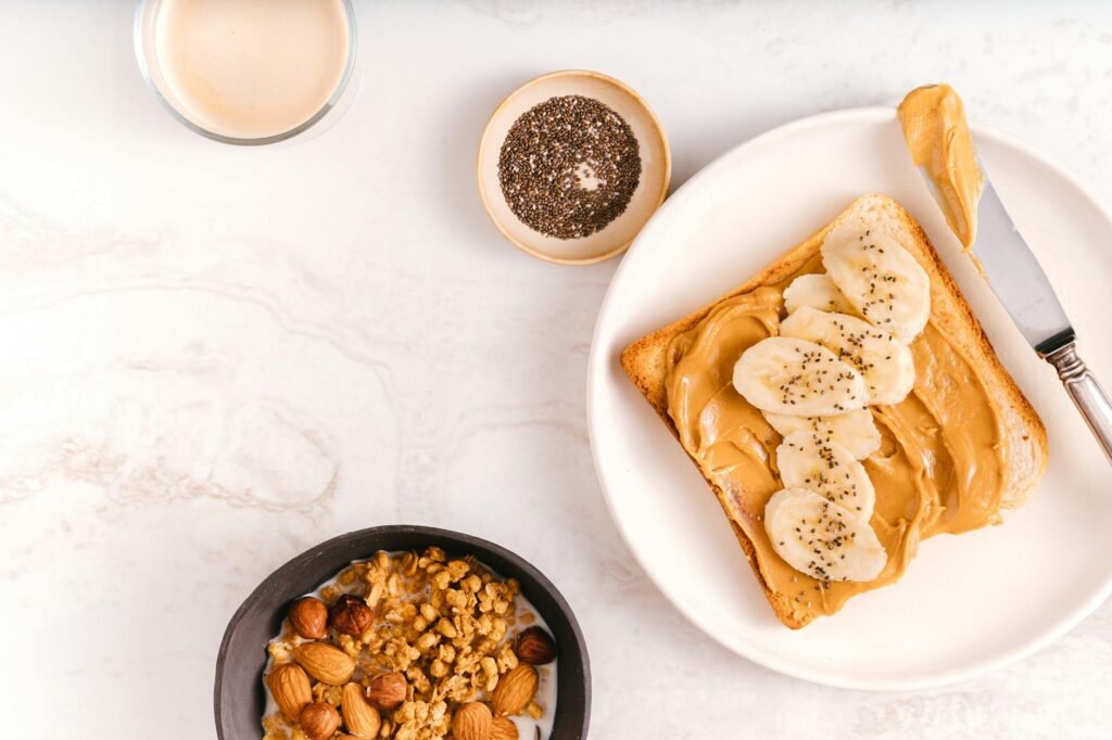 A vegan breakfast setup with oatmeal, soy milk, fruit, and nut butter