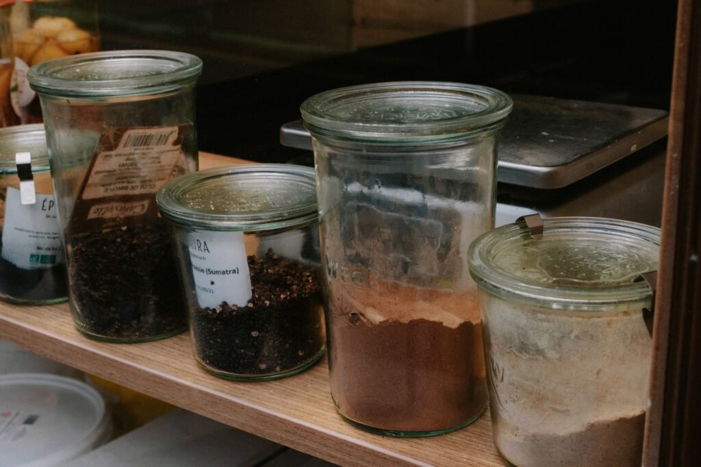 A neatly organized pantry shelf with miso, dried mushrooms, nutritional yeast, and other savory staples