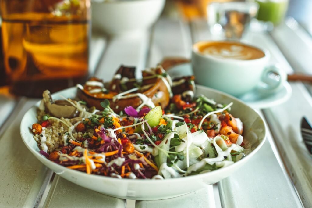 A lentil and quinoa bowl topped with cabbage, carrots, cucumbers, and pumpkin seeds